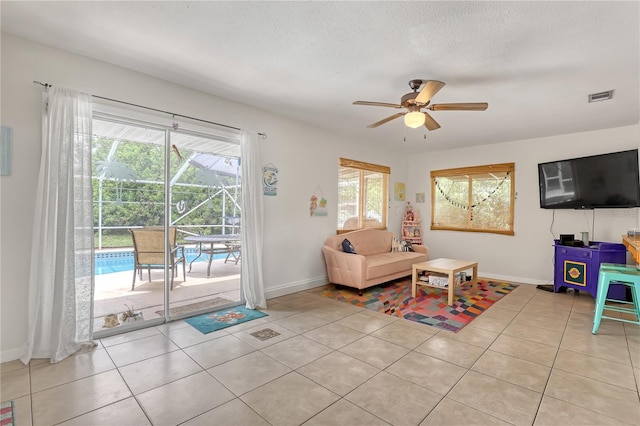 1340 NE Mariposa Dr NE, Palm Bay, FL 32905 - living room with a ceiling fan and light tile patterned floors