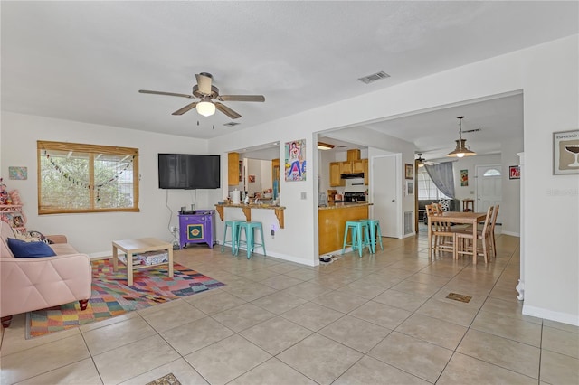 1340 NE Mariposa Dr NE, Palm Bay, FL 32905 - living room with ceiling fan and light tile patterned floors