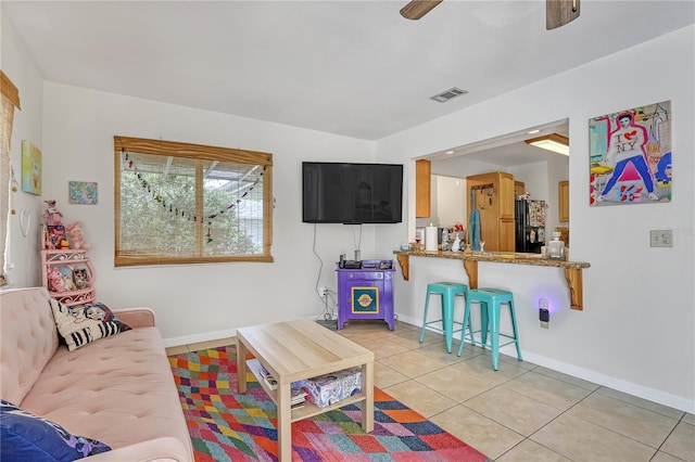 1340 NE Mariposa Dr NE, Palm Bay, FL 32905 - living room with light tile patterned flooring and a ceiling fan