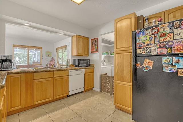 1340 NE Mariposa Dr NE, Palm Bay, FL 32905 - kitchen with black appliances, washing machine and clothes dryer, light tile patterned flooring, light stone counters, and recessed lighting