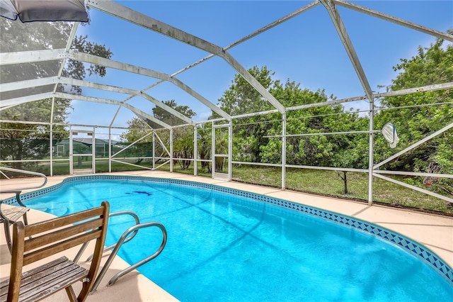 1340 NE Mariposa Dr NE, Palm Bay, FL 32905 - swimming pool featuring glass enclosure and a patio