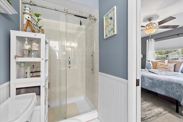 2850 Doone Cir, Palm Harbor, FL 34684 - ensuite bathroom with a stall shower, wainscoting, and a ceiling fan