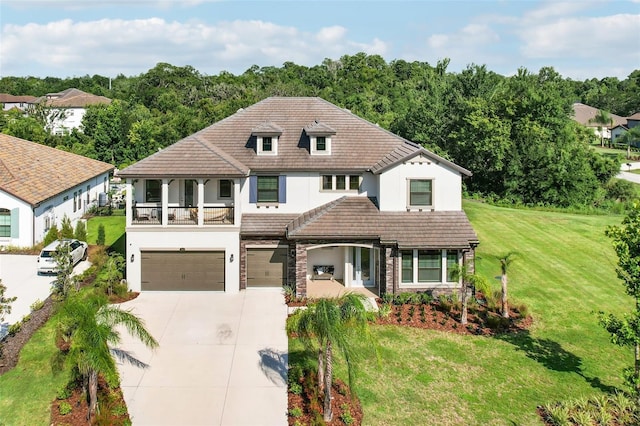2903 Cordoba Ranch Blvd, Lutz, FL 33559 - view of front facade with stucco siding, a garage, driveway, a front yard, and a balcony