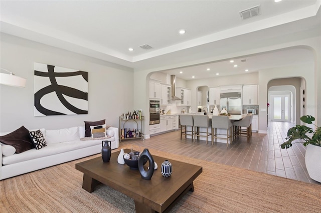2903 Cordoba Ranch Blvd, Lutz, FL 33559 - living area featuring arched walkways, recessed lighting, and light wood-style floors