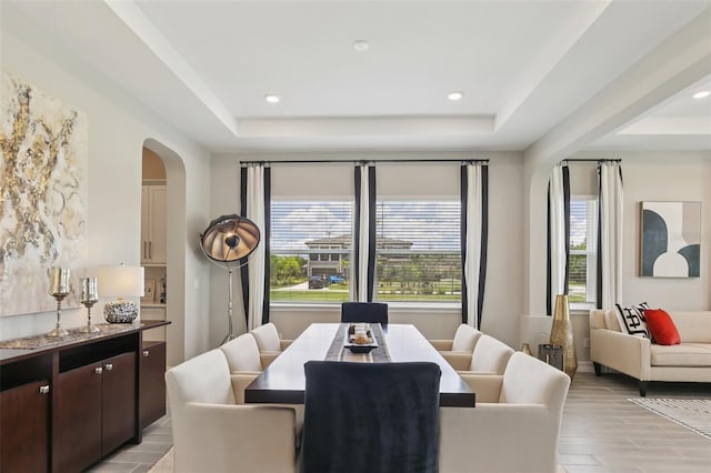 2903 Cordoba Ranch Blvd, Lutz, FL 33559 - dining space featuring a raised ceiling, arched walkways, light wood-style floors, and recessed lighting