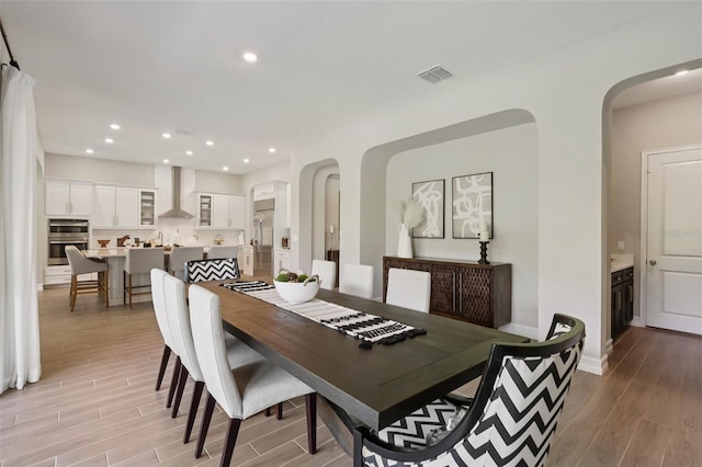 2903 Cordoba Ranch Blvd, Lutz, FL 33559 - dining area with light wood-style flooring, recessed lighting, and arched walkways