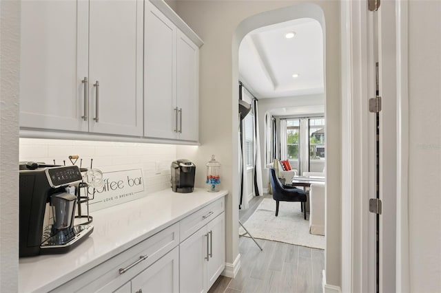 2903 Cordoba Ranch Blvd, Lutz, FL 33559 - kitchen featuring backsplash, white cabinetry, light countertops, wood finished floors, and recessed lighting