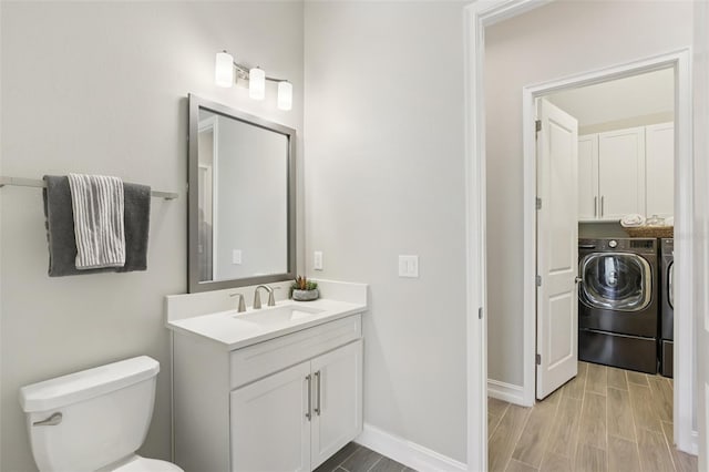 2903 Cordoba Ranch Blvd, Lutz, FL 33559 - bathroom with washer and clothes dryer, vanity, and wood finished floors