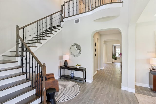 2903 Cordoba Ranch Blvd, Lutz, FL 33559 - foyer entrance featuring wood finished floors, stairway, arched walkways, and a towering ceiling