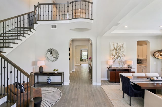 2903 Cordoba Ranch Blvd, Lutz, FL 33559 - entryway with arched walkways, stairway, light wood-type flooring, recessed lighting, and a high ceiling