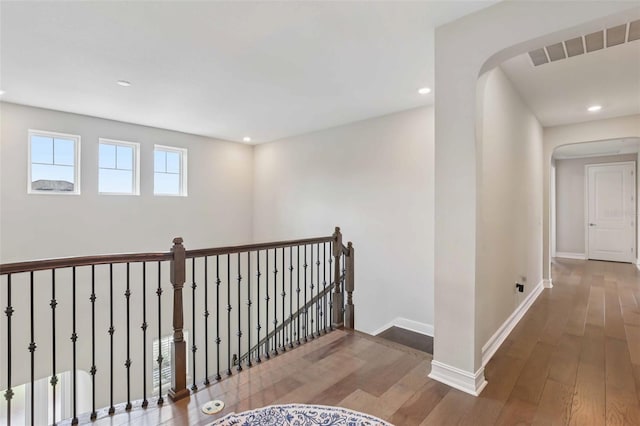 2903 Cordoba Ranch Blvd, Lutz, FL 33559 - hallway featuring hardwood / wood-style floors, arched walkways, an upstairs landing, and recessed lighting