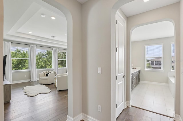 2903 Cordoba Ranch Blvd, Lutz, FL 33559 - hallway with arched walkways, plenty of natural light, wood finished floors, and recessed lighting