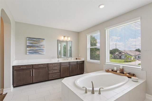 2903 Cordoba Ranch Blvd, Lutz, FL 33559 - bathroom featuring vanity, a garden tub, and tile patterned floors