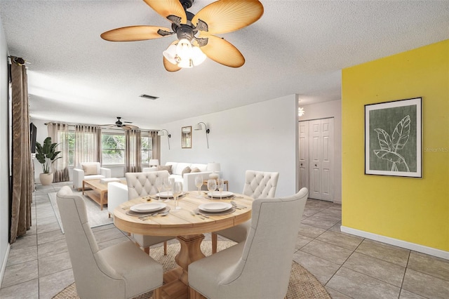 5623 80th St N Unit 415, Saint Petersburg, FL 33709 - dining room with ceiling fan, a textured ceiling, and light tile patterned floors