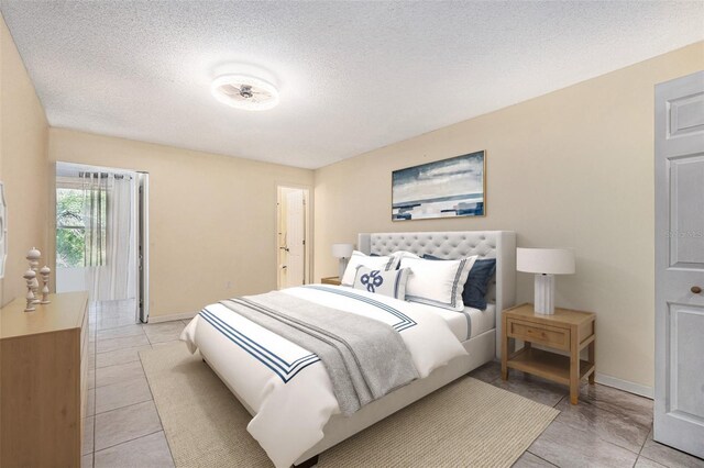 5623 80th St N Unit 415, Saint Petersburg, FL 33709 - bedroom featuring light tile patterned floors and a textured ceiling