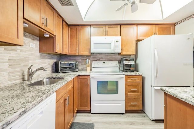 2700 Bayshore Blvd Unit 6210, Dunedin, FL 34698 - kitchen featuring white appliances, decorative backsplash, light stone countertops, and ceiling fan