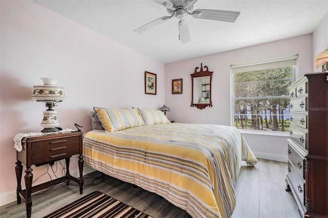 2700 Bayshore Blvd Unit 6210, Dunedin, FL 34698 - bedroom with light wood-style floors, ceiling fan, and a textured ceiling