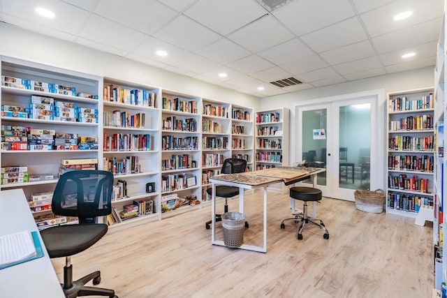2700 Bayshore Blvd Unit 6210, Dunedin, FL 34698 - office featuring bookshelves, a drop ceiling, wood finished floors, and french doors