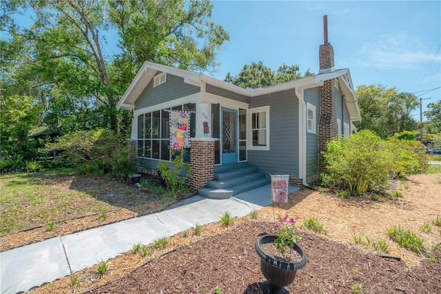 917 W Idlewild Ave, Tampa, FL 33604 - view of front facade featuring a chimney and a sunroom