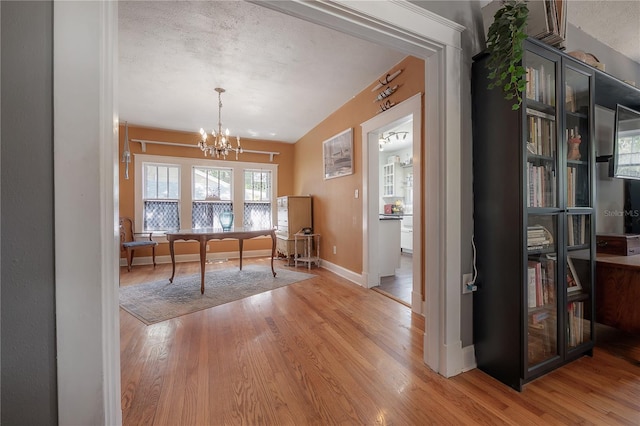 917 W Idlewild Ave, Tampa, FL 33604 - dining area with light wood-style flooring, a chandelier, and vaulted ceiling