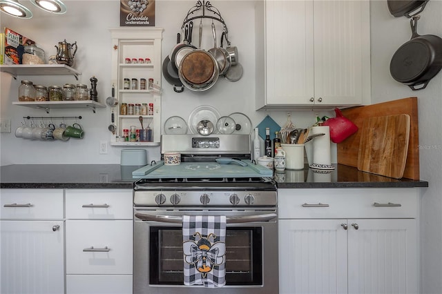 917 W Idlewild Ave, Tampa, FL 33604 - kitchen with stainless steel range with gas stovetop, dark countertops, white cabinetry, and open shelves