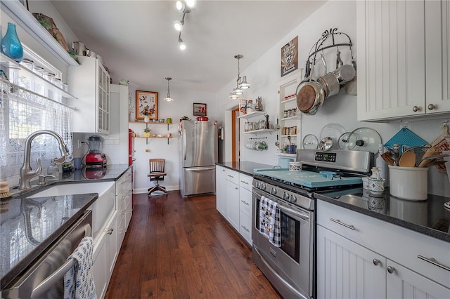 917 W Idlewild Ave, Tampa, FL 33604 - kitchen with stainless steel appliances, decorative backsplash, white cabinetry, dark wood-type flooring, and glass insert cabinets