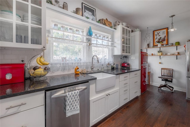 917 W Idlewild Ave, Tampa, FL 33604 - kitchen featuring appliances with stainless steel finishes, dark wood-style floors, white cabinetry, and decorative backsplash