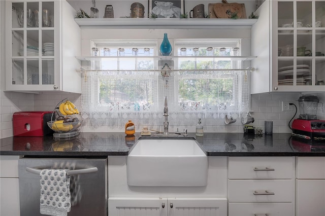 917 W Idlewild Ave, Tampa, FL 33604 - kitchen with stainless steel dishwasher, white cabinets, backsplash, and glass insert cabinets