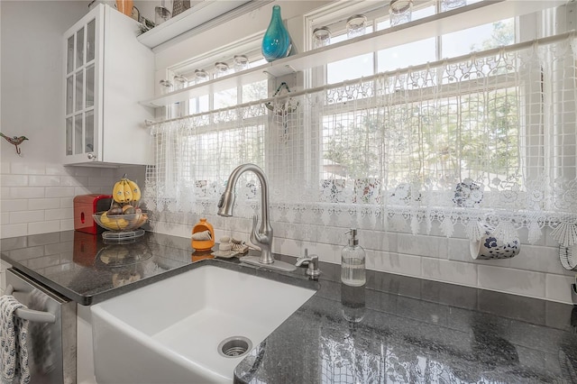 917 W Idlewild Ave, Tampa, FL 33604 - kitchen with backsplash, open shelves, glass insert cabinets, and stainless steel dishwasher