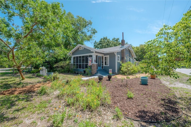 917 W Idlewild Ave, Tampa, FL 33604 - view of front of property with a sunroom and a chimney