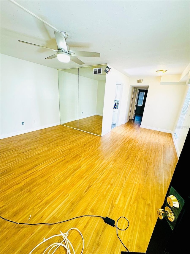 4611 W N B St Unit 228, Tampa, FL 33609 - unfurnished living room featuring light wood-type flooring and a ceiling fan