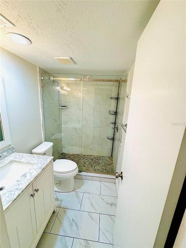 4611 W N B St Unit 228, Tampa, FL 33609 - full bathroom featuring vanity, a marble finish shower, marble finish floors, and a textured ceiling