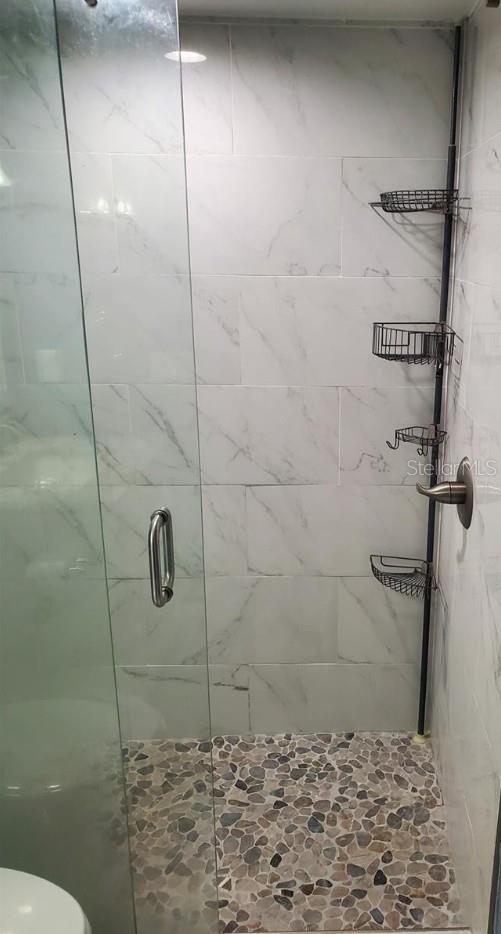 4611 W N B St Unit 228, Tampa, FL 33609 - bathroom with a shower stall and toilet