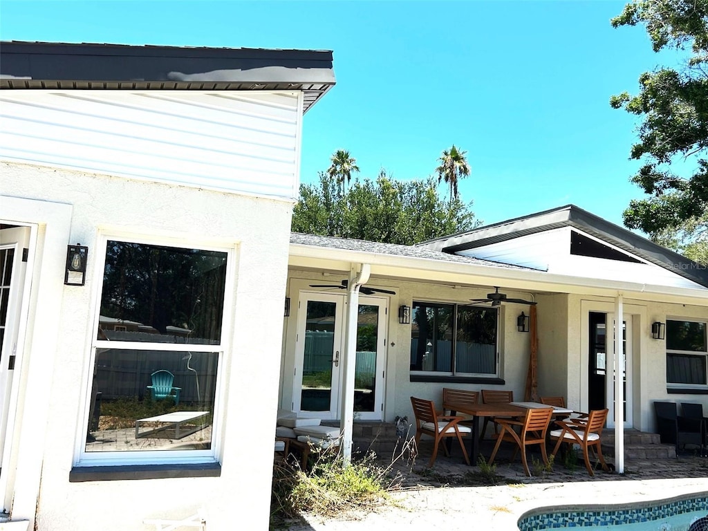 3811 Huntington St NE, Saint Petersburg, FL 33703 - rear view of property featuring a ceiling fan, a patio area, stucco siding, and outdoor dining area