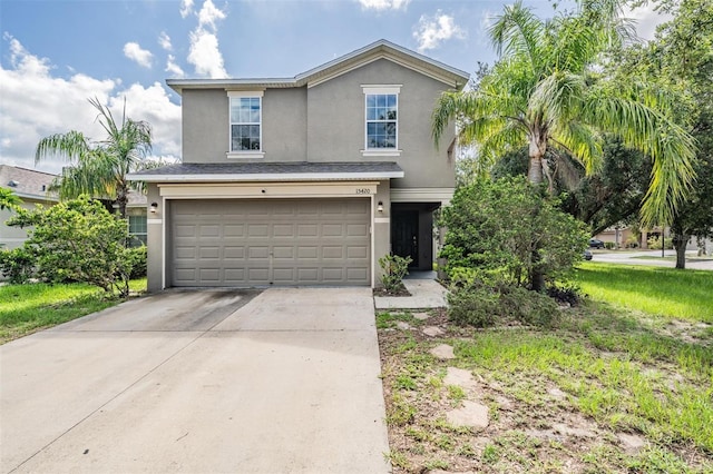 15420 Quail Woods Pl, Ruskin, FL 33573 - traditional-style home featuring stucco siding, an attached garage, and driveway