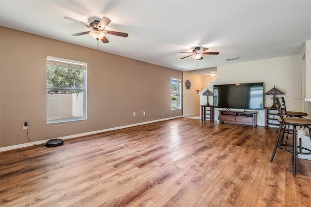15420 Quail Woods Pl, Ruskin, FL 33573 - unfurnished living room with a ceiling fan, plenty of natural light, and wood finished floors