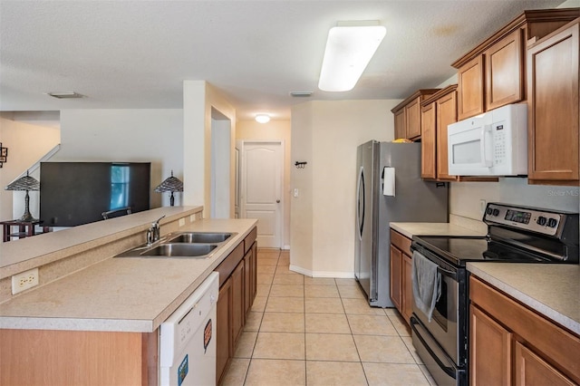 15420 Quail Woods Pl, Ruskin, FL 33573 - kitchen featuring white appliances, brown cabinetry, light tile patterned floors, and light countertops