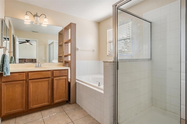 15420 Quail Woods Pl, Ruskin, FL 33573 - bathroom featuring a ceiling fan, a bath, a stall shower, tile patterned flooring, and vanity