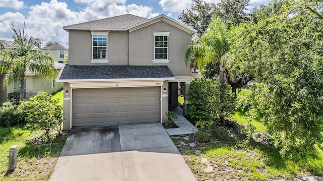 15420 Quail Woods Pl, Ruskin, FL 33573 - traditional home with stucco siding, an attached garage, driveway, and roof with shingles