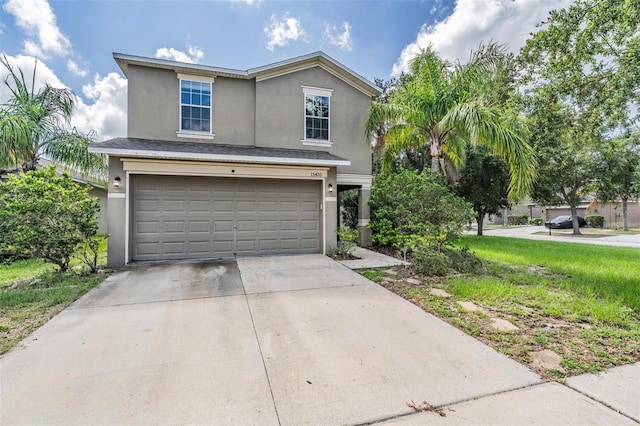 15420 Quail Woods Pl, Ruskin, FL 33573 - traditional home featuring stucco siding, an attached garage, and concrete driveway