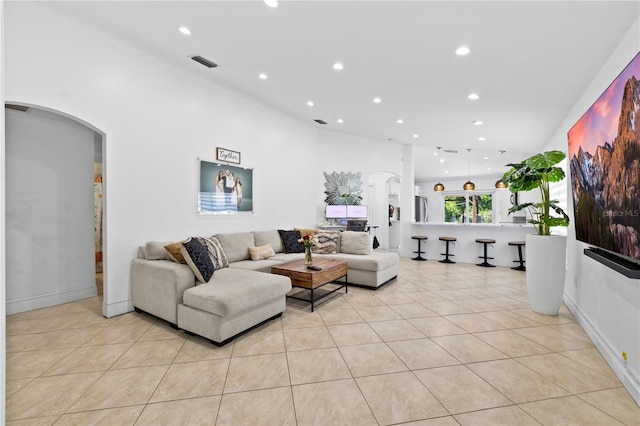 9831 Edmonton Dr, Land O Lakes, FL 34638 - living area featuring arched walkways, light tile patterned floors, and recessed lighting
