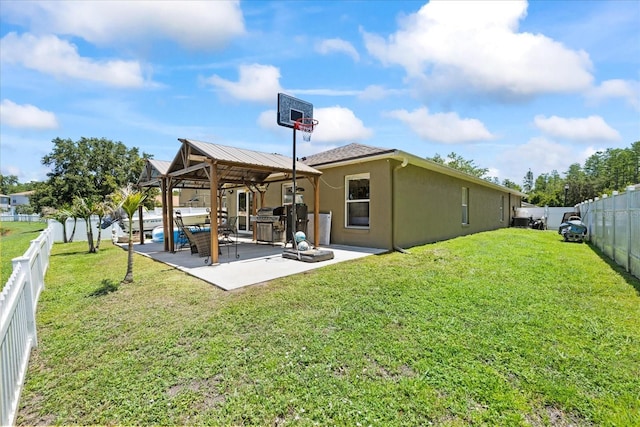 9831 Edmonton Dr, Land O Lakes, FL 34638 - back of house featuring a gazebo, stucco siding, a fenced backyard, and a patio