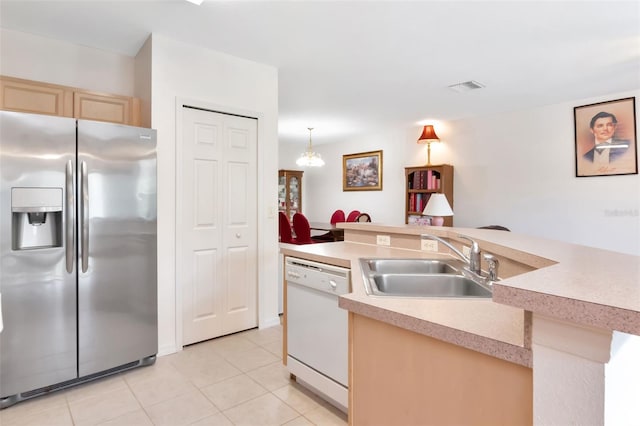 6231 Olivedale Dr, Riverview, FL 33578 - kitchen featuring stainless steel refrigerator with ice dispenser, white dishwasher, light tile patterned floors, light brown cabinets, and light countertops
