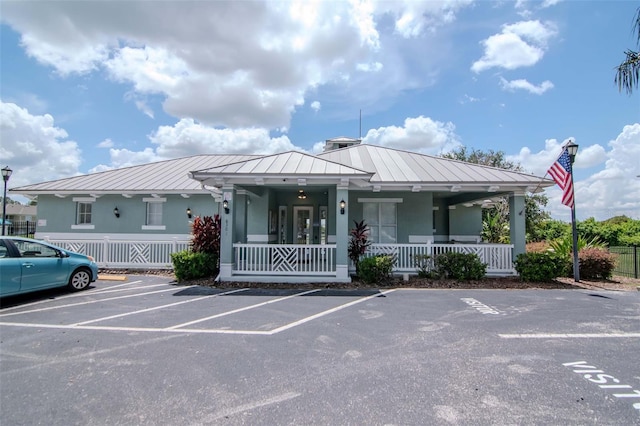 6231 Olivedale Dr, Riverview, FL 33578 - view of front facade with a porch, uncovered parking, a metal roof, a standing seam roof, and stucco siding