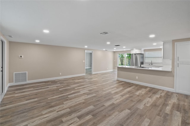 561 Golf And Sea Blvd, Apollo Beach, FL 33572 - unfurnished living room featuring recessed lighting and light wood-style flooring