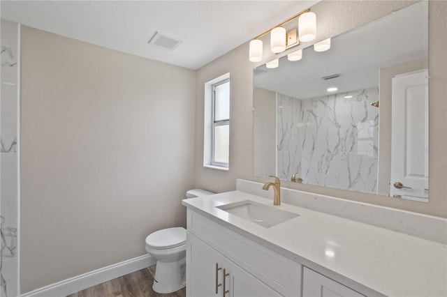 561 Golf And Sea Blvd, Apollo Beach, FL 33572 - bathroom with vanity, a marble finish shower, and wood finished floors