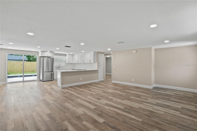 561 Golf And Sea Blvd, Apollo Beach, FL 33572 - unfurnished living room featuring light wood-style floors and recessed lighting
