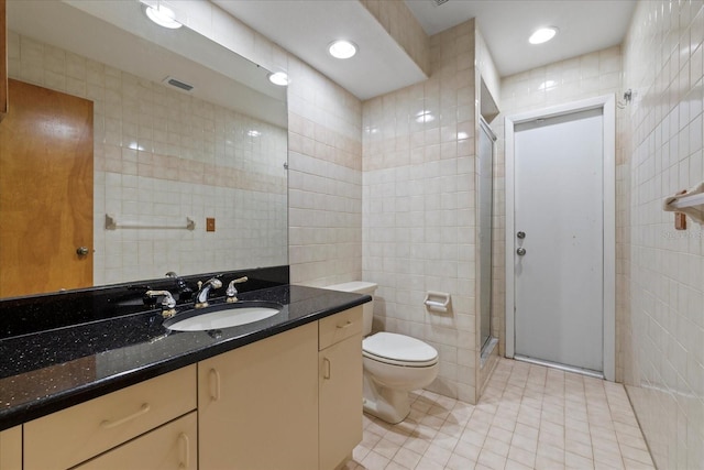 6706 Dunes Ln, Temple Terrace, FL 33617 - bathroom featuring tile walls, tile patterned flooring, vanity, and a stall shower
