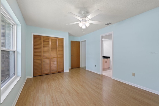 6706 Dunes Ln, Temple Terrace, FL 33617 - unfurnished bedroom featuring light wood-style floors, a closet, a ceiling fan, and ensuite bath