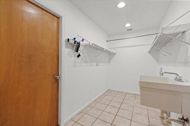 6706 Dunes Ln, Temple Terrace, FL 33617 - walk in closet featuring light tile patterned floors and a sink